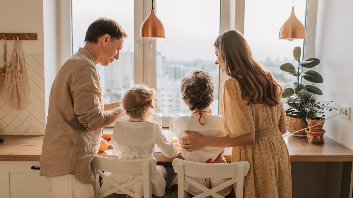 A family enjoying breakfast together in a warm sunlit kitchen, fostering togetherness.